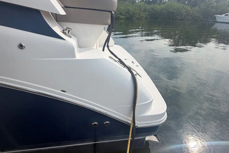 Slide: The Image of 2017 Regal 32 Express boat docked on calm water. - 42