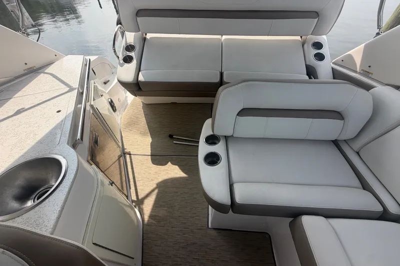Slide: The Image of 2017 Regal 32 Express boat interior with seating and kitchenette area. - 27