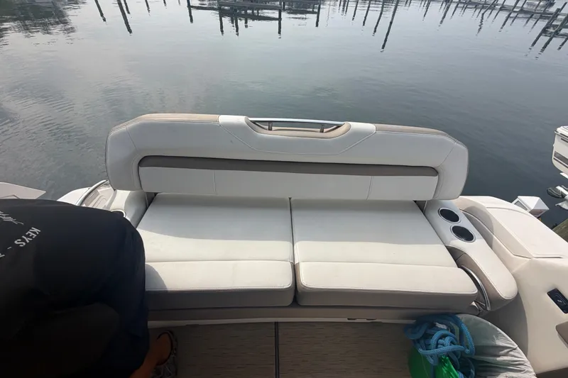Slide: The Image of Rear seating area of a 2017 Regal 32 Express boat by the water. - 31