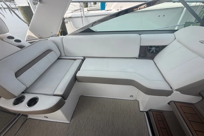 Slide: The Image of Luxurious seating area on a 2017 Regal 32 Express boat with cup holders. - 6