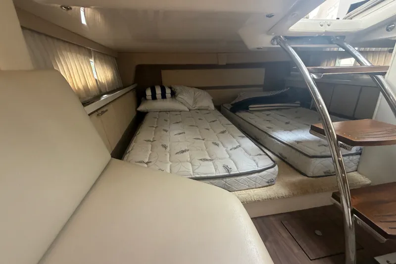 Slide: The Image of Interior cabin of 2017 Regal 32 Express yacht with twin beds and ladder access. - 16