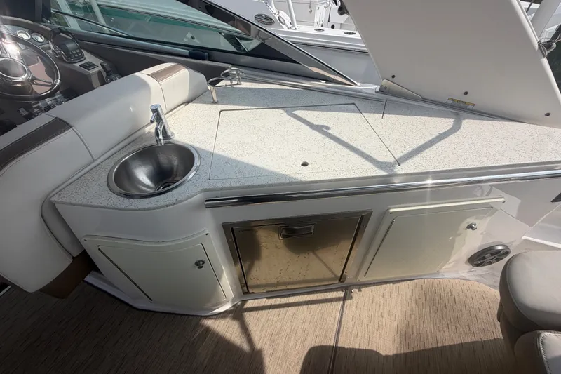 Slide: The Image of 2017 Regal 32 Express boat interior with sink and storage cabinets. - 28