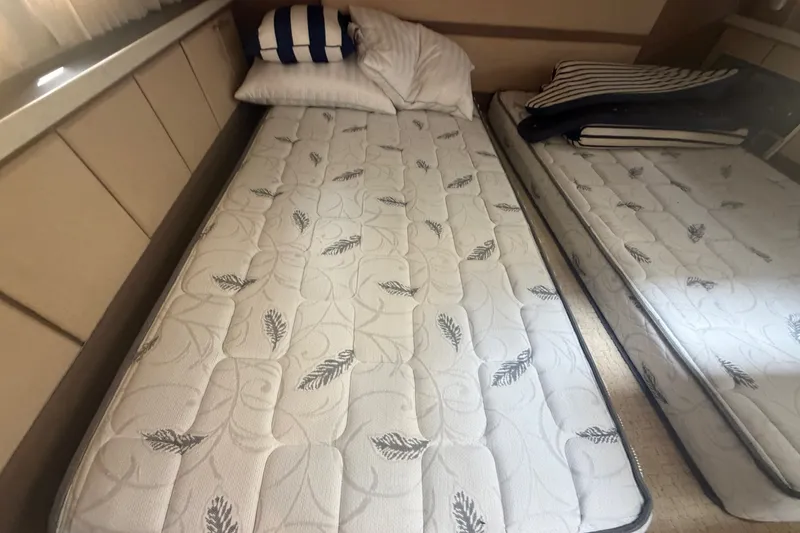 Slide: The Image of Cabin interior of 2017 Regal 32 Express with twin beds and striped pillows. - 18