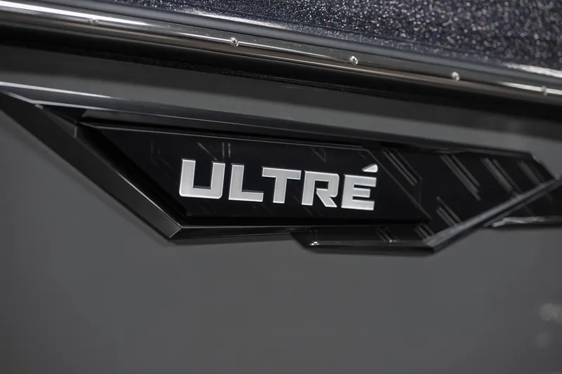 Slide: The Image of 2026 Tigé Ultré 25ZX boat logo on sleek black surface. - 39