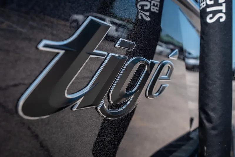 Slide: The Image of Close-up of 2026 Tigé Ultré 25ZX logo on a sleek boat exterior. - 6