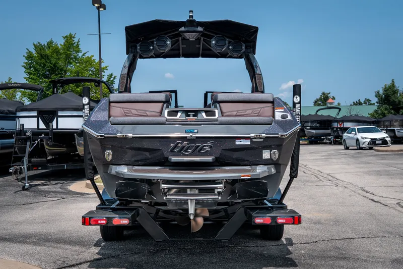 Slide: The Image of 2026 Tigé Ultré 25ZX boat rear view in a parking lot, showcasing sleek design and features. - 9