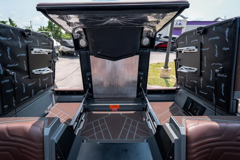 Slide: The Image of 2026 Tigé Ultré 25ZX boat interior with open storage compartments and sleek design. - 46