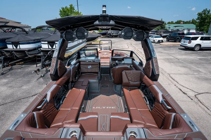 Slide: The Image of 2026 Tigé Ultré 25ZX boat interior with luxurious brown seating and advanced dashboard. - 21