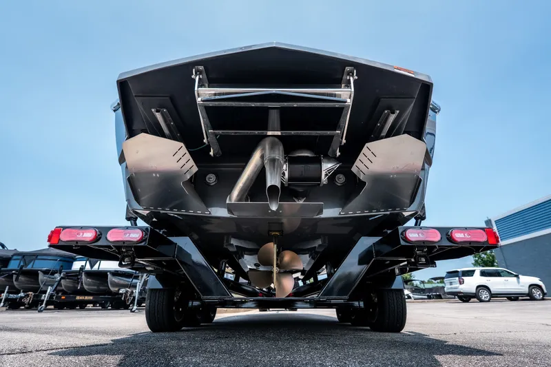 Slide: The Image of Rear view of 2026 Tigé Ultré 25ZX boat on trailer, showcasing hull and propeller. - 10