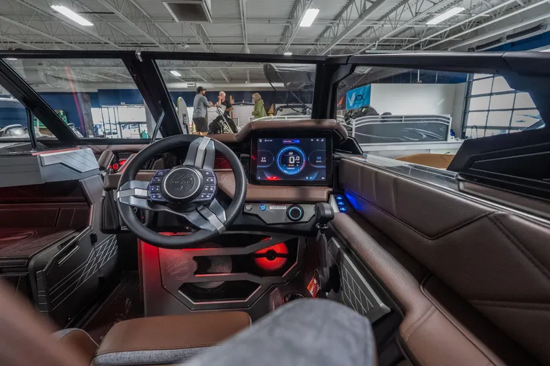 Slide: The Image of Interior of 2026 Tigé Ultré 25ZX boat with modern dashboard and steering wheel. - 12