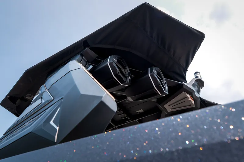 Slide: The Image of 2026 Tigé Ultré 25ZX boat with advanced speaker system and sleek design under a canopy. - 5