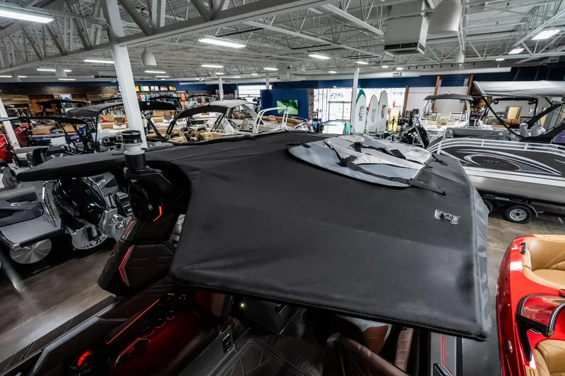 Slide: The Image of 2026 Tigé Ultré 25ZX boat with black canopy in showroom. - 42