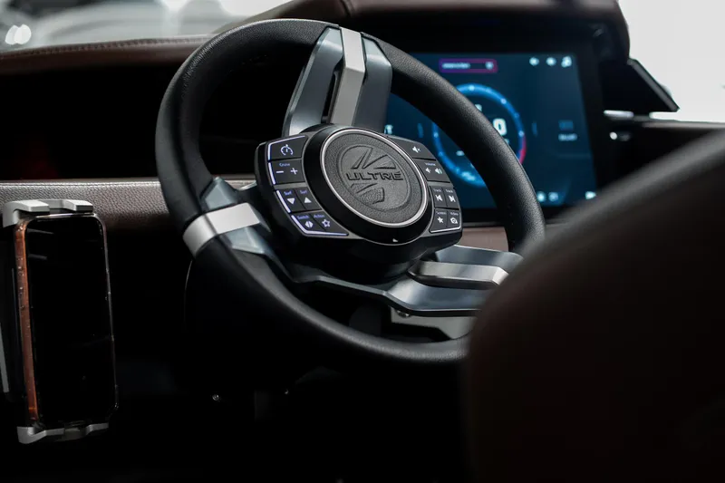 Slide: The Image of Steering wheel of 2026 Tigé Ultré 25ZX boat with advanced controls and digital display. - 34
