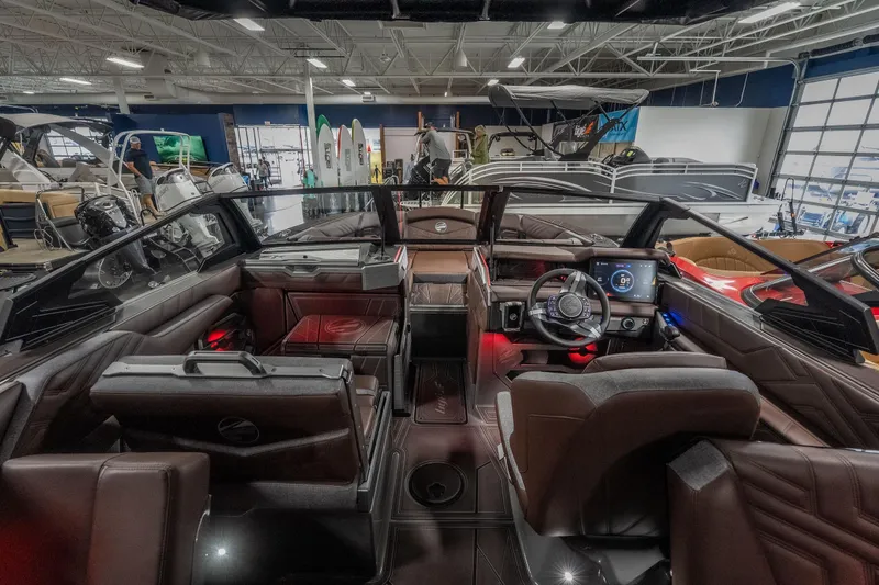 Slide: The Image of Interior of 2026 Tigé Ultré 25ZX boat with modern dashboard and luxurious seating. - 13
