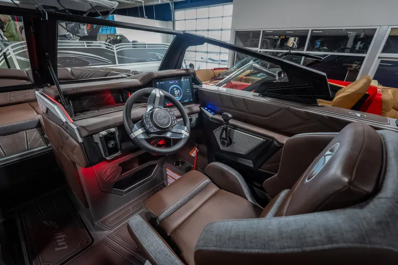 Slide: The Image of Interior of 2026 Tigé Ultré 25ZX boat with modern dashboard and steering wheel. - 9