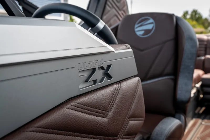 Slide: The Image of 2026 Tigé Ultré 25ZX boat interior with sleek design and luxurious brown seating. - 33