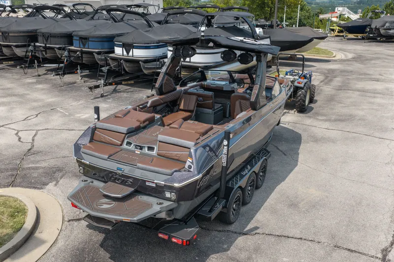 Slide: The Image of 2026 Tigé Ultré 25ZX boat on trailer, parked in a marina lot. - 7