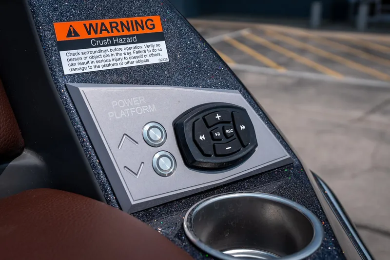 Slide: The Image of Control panel of 2026 Tigé Ultré 25ZX boat with warning label and cup holder. - 18