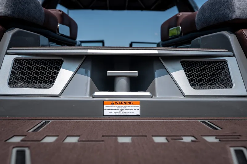 Slide: The Image of 2026 Tigé Ultré 25ZX boat interior with warning label and seating. - 19