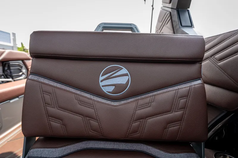 Slide: The Image of Brown leather seat with logo in 2026 Tigé Ultré 25ZX boat interior. - 36