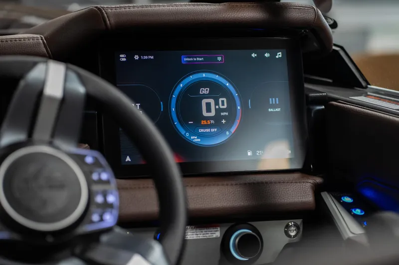 Slide: The Image of 2026 Tigé Ultré 25ZX dashboard with digital display and steering wheel. - 11