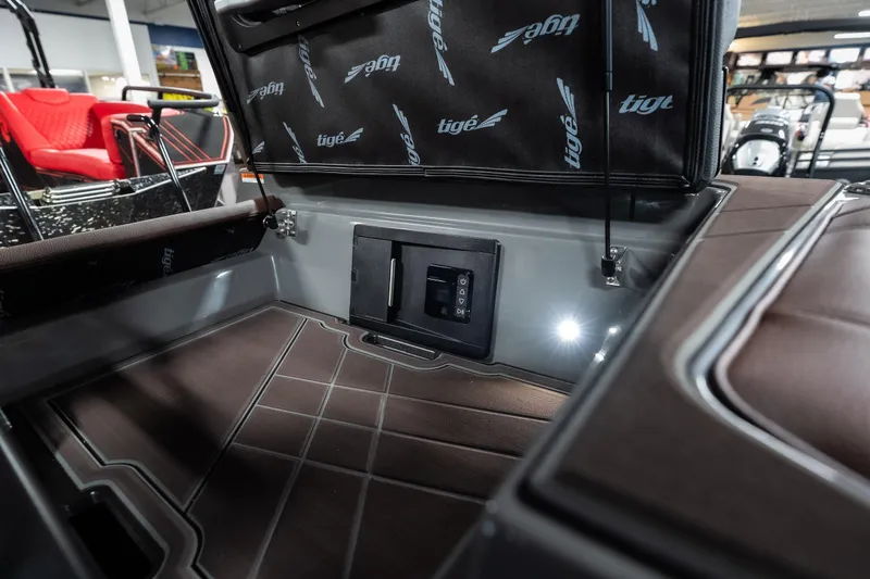Slide: The Image of Interior storage compartment of 2026 Tigé Ultré 25ZX boat, featuring sleek design and lighting. - 41