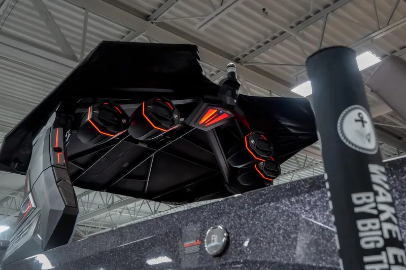Slide: The Image of 2026 Tigé Ultré 25ZX boat with advanced audio system and sleek design in showroom. - 26