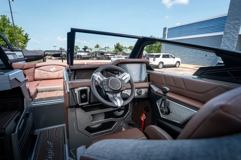 Slide: The Image of Interior view of 2026 Tigé Ultré 25ZX boat with modern dashboard and steering wheel. - 28
