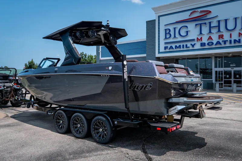 Slide: The Image of 2026 Tigé Ultré 25ZX boat on trailer at Big Thunder Marine dealership. - 14