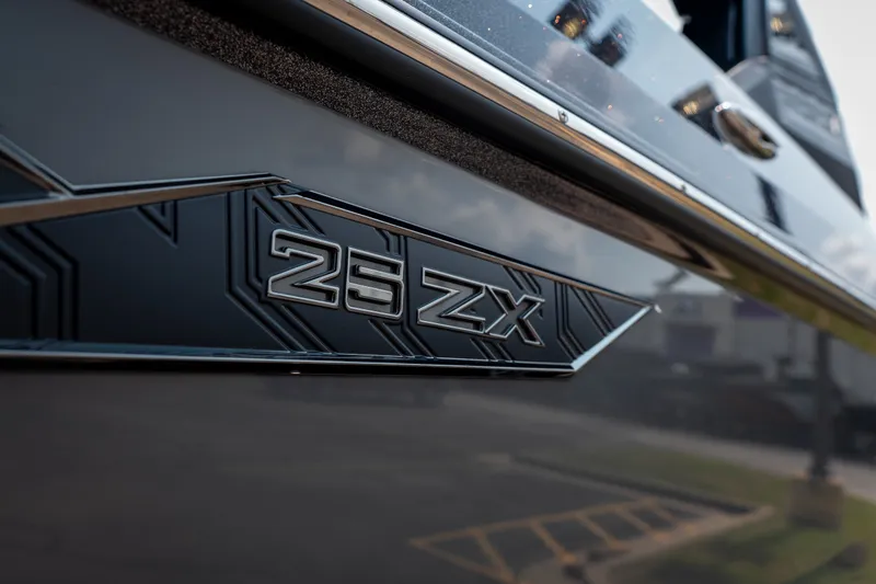 Slide: The Image of 2026 Tigé Ultré 25ZX boat emblem close-up, showcasing sleek design details. - 4