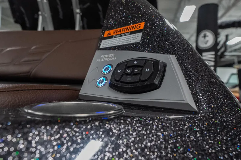 Slide: The Image of Control panel of 2026 Tigé Ultré 25ZX boat with glitter finish and warning label. - 40