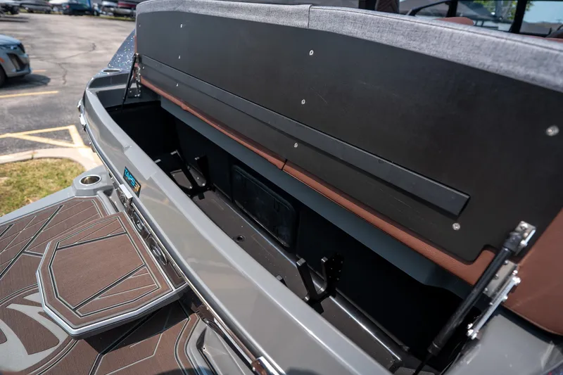 Slide: The Image of 2026 Tigé Ultré 25ZX boat storage compartment with open hatch, showcasing interior space. - 16