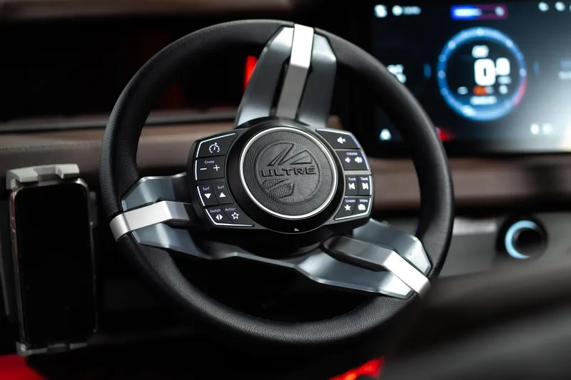 Slide: The Image of Steering wheel of 2026 Tigé Ultré 25ZX boat with advanced controls and digital display. - 10