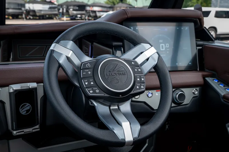 Slide: The Image of Steering wheel and dashboard of 2026 Tigé Ultré 25ZX boat, featuring modern controls and touchscreen. - 29