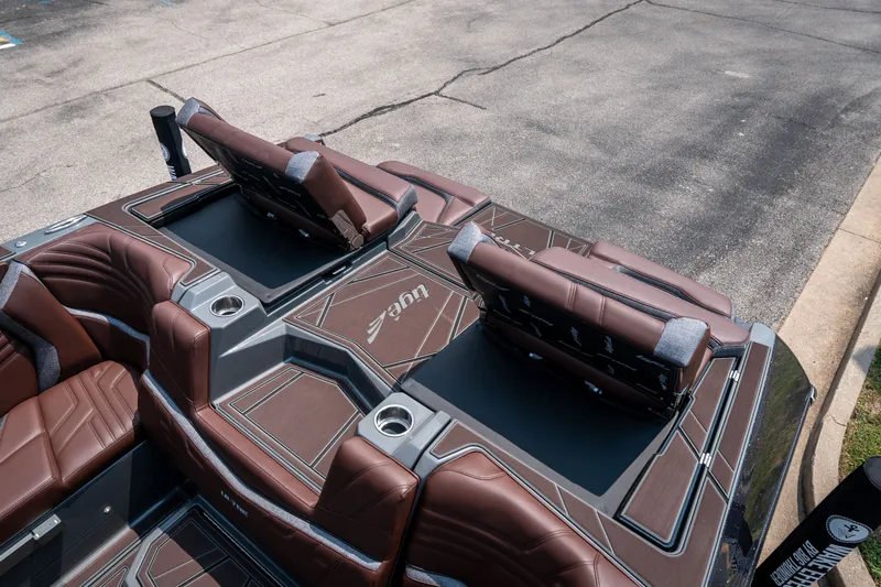 Slide: The Image of 2026 Tigé Ultré 25ZX boat interior with brown leather seating and storage compartments. - 43