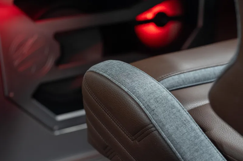 Slide: The Image of Close-up of Tigé Ultré 25ZX 2026 boat seat with red ambient lighting. - 32