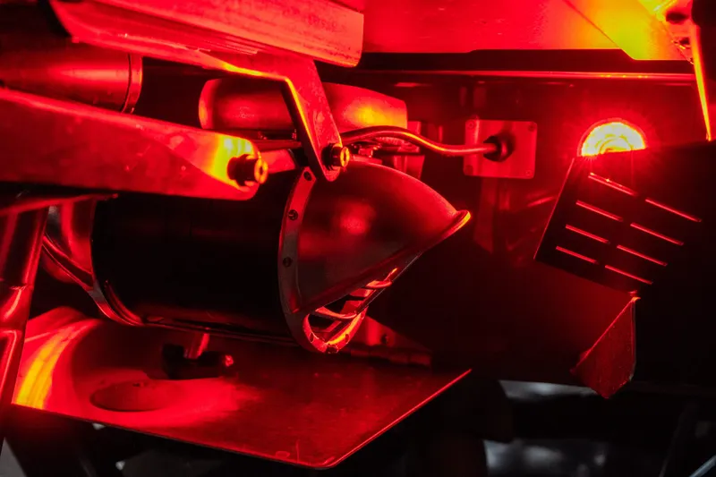 Slide: The Image of Close-up of 2026 Tigé Ultré 25ZX boat's illuminated red mechanical components. - 5