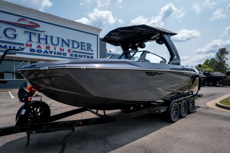 Slide: The Image of 2026 Tigé Ultré 25ZX boat on trailer at Big Thunder Marine dealership. - 1