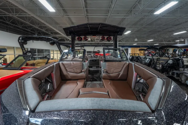 Slide: The Image of 2026 Tigé Ultré 25ZX boat interior with luxurious seating in a showroom. - 18