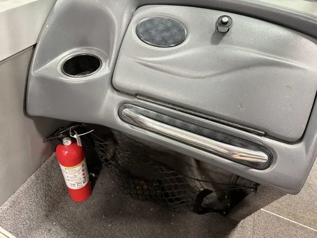 Slide: The Image of The image shows a boat's dashboard with a cup holder and a fire extinguisher. - 14