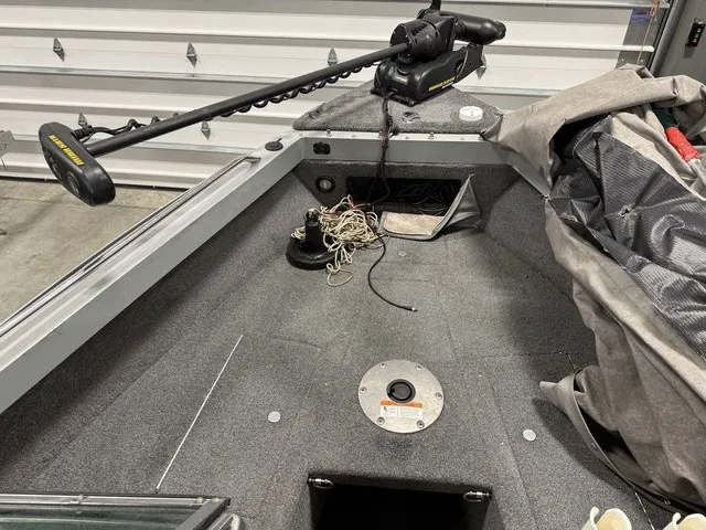 Slide: The Image of Interior view of a 2006 Lund 1800 Fisherman with gray carpet and fishing gear. - 22