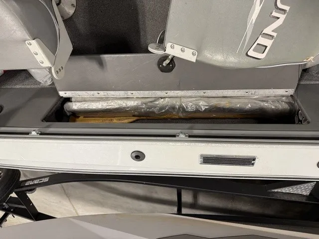 Slide: The Image of A view of the storage compartment in a 2006 Lund 1800 Fisherman boat with gray seats. - 19