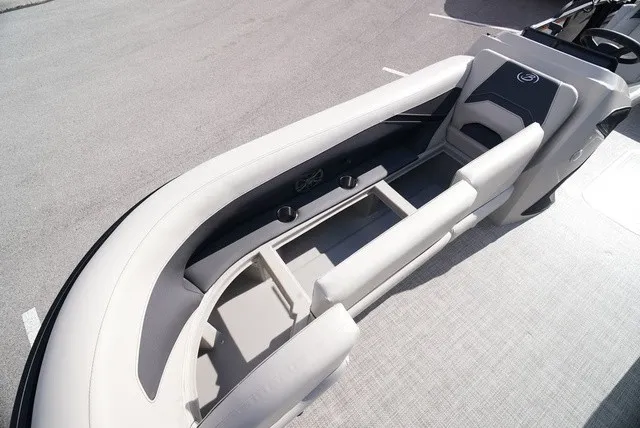 Slide: The Image of The image shows the deck of a Barletta A24UC boat with sleek seating and cup holders. - 35