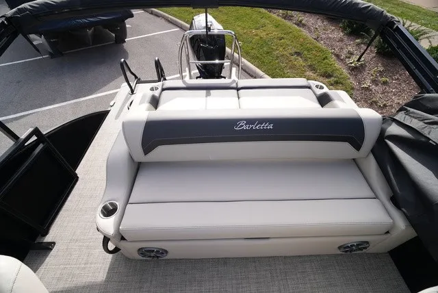 Slide: The Image of The image shows the rear of a Barletta A24UC boat with a cushioned bench seat. - 13