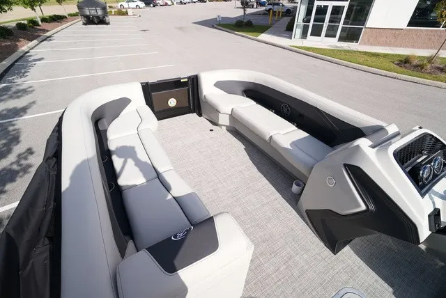 Slide: The Image of The image shows the spacious deck of a Barletta A24UC boat with sleek seating. - 29