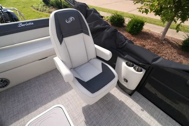 Slide: The Image of A sleek, cushioned captain's chair on a Barletta boat, surrounded by gray carpeting. - 25