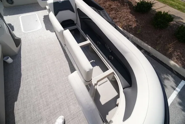 Slide: The Image of The image shows the interior of a Barletta A24UC boat with gray upholstery and an open storage area. - 33