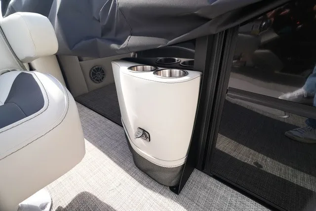 Slide: The Image of A sleek cup holder in a modern boat, surrounded by stylish seating and carpeted flooring. - 26