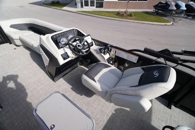 Slide: The Image of The image shows the cockpit of a Barletta A24UC boat with a modern helm and comfortable seating. - 19