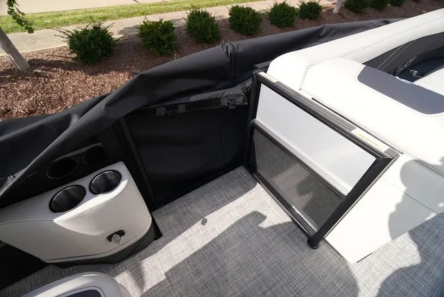 Slide: The Image of The image shows the interior of a Barletta A24UC boat with gray carpeting and cup holders. - 28